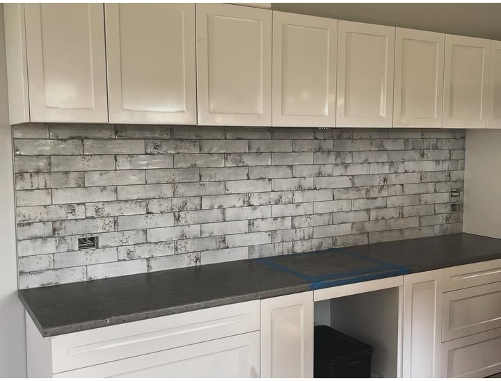 Contemporary kitchen with professionally installed geometric backsplash pattern